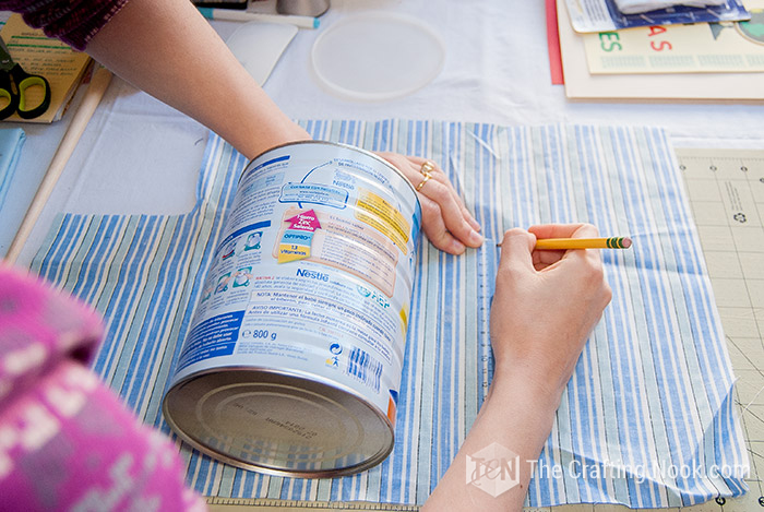 Measuring the height of the can and marking it on fabric
