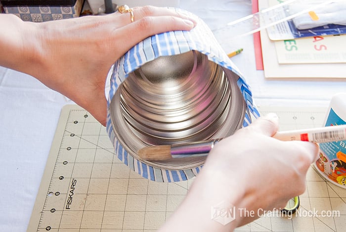 applying glue to the inside edge of the can
