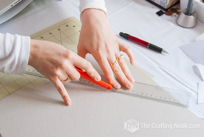 view of I cutting the pattern with a ruler and cutter