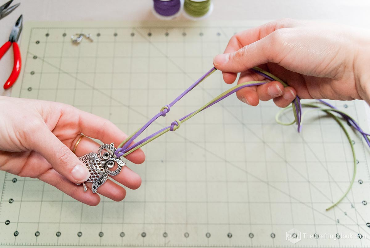 showing the knots made with the two different colored cords on each side of the necklace