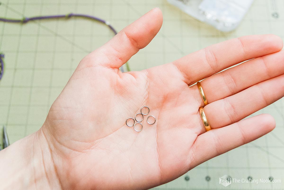 showing some jump rings in the palm of the hand