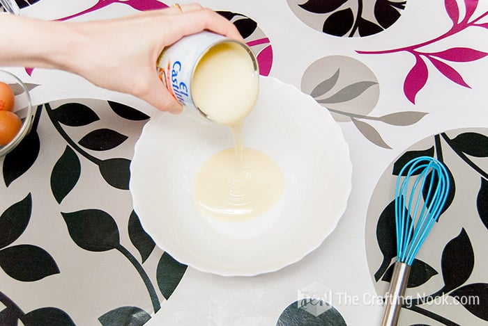 Pouring the condensed milk into a bowl