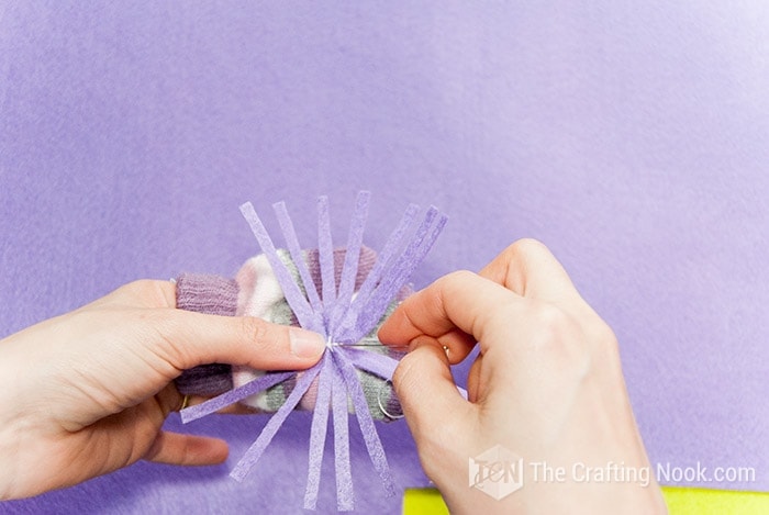 Sewing the felt hair onto the glove
