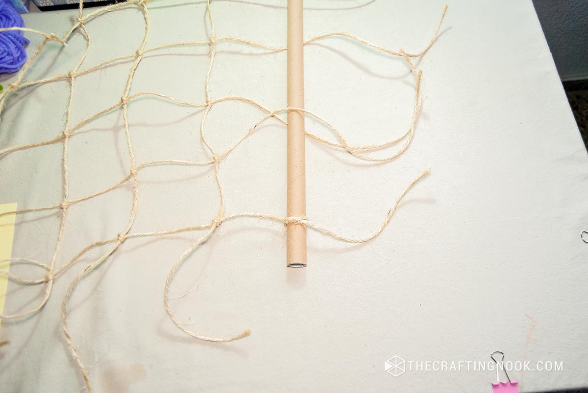 tying the second paper tube to the end of the knot net