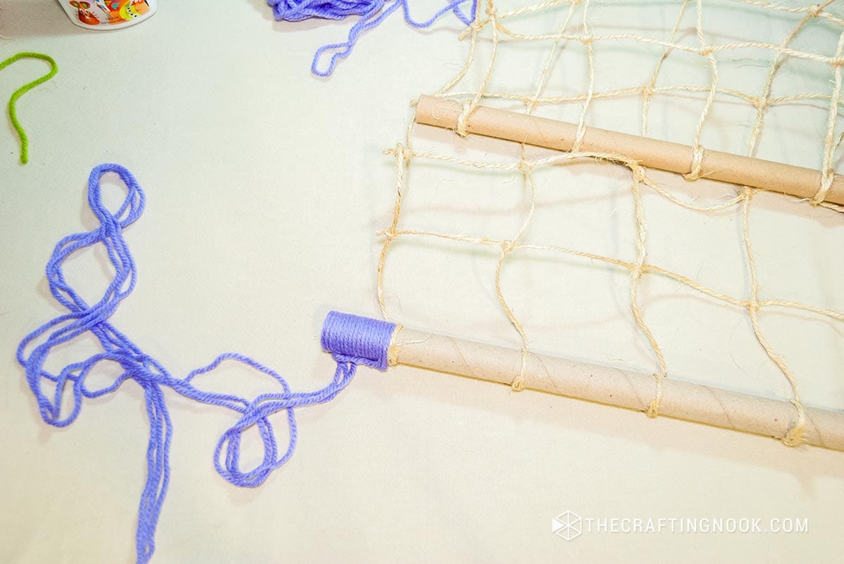 winding the ends of the paper tube with violet thread