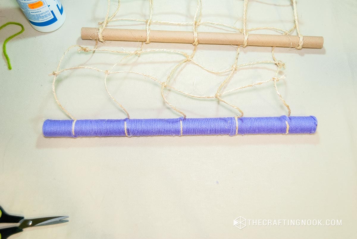 showing the paper tube fully covered by purple thread