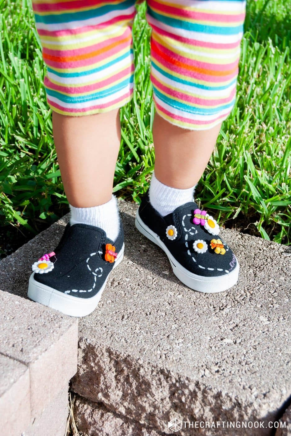 my daughter wearing the new diy embellished shoes on the front yeard in a different pose