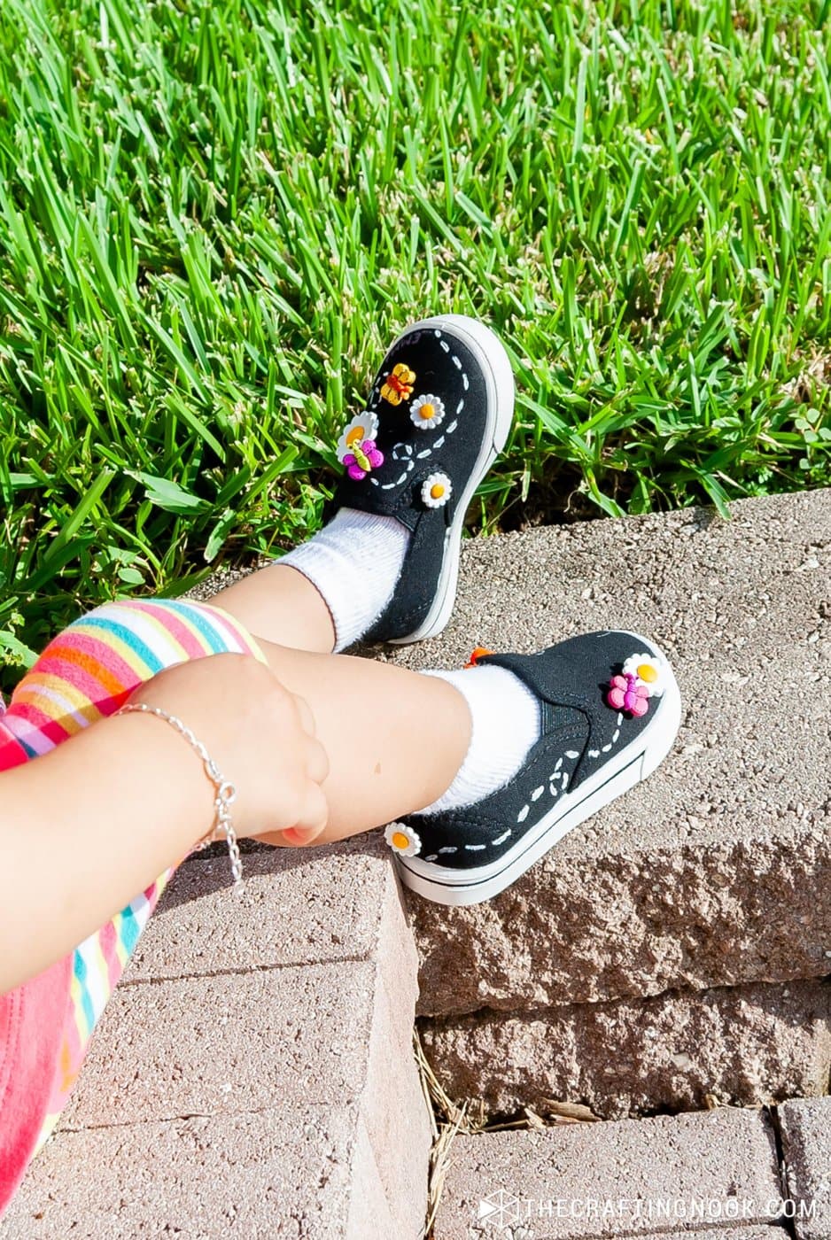 my daughter wearing the new diy embellished shoes playing ouside