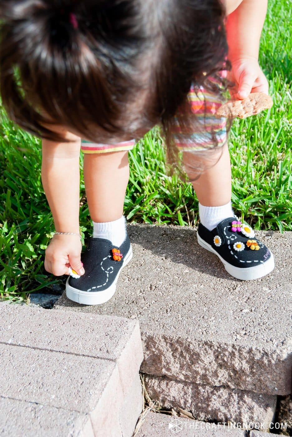 my daughter wearing the new diy embellished shoes on the front yeard