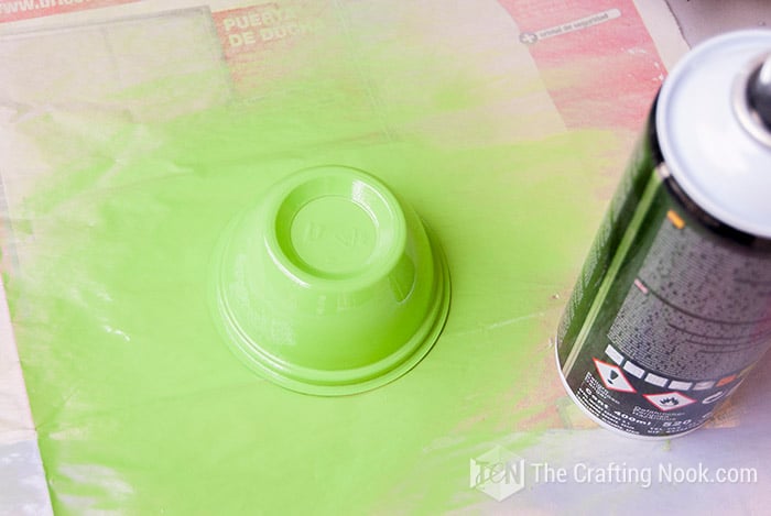 image of a small container painted with green spray
