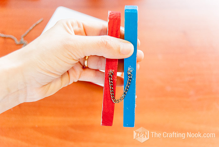 showing  a piece of chain glued with hot glue gun to connect both letters