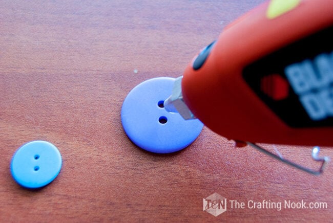 placing hot glue on botton