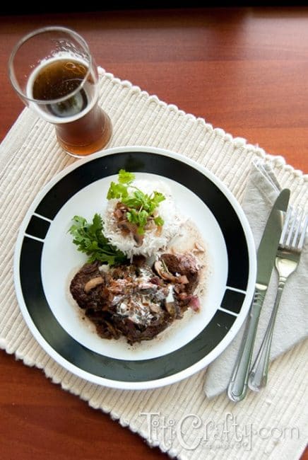 top view of tenderloin Steaks in Red Wine Mushroom Sauce served on a plate accompanied with white rice
