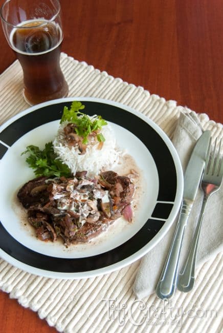 top view of tenderloin Steaks in Red Wine Mushroom Sauce served on a plate accompanied with white rice
