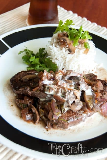 closeup of tenderloin  Steaks in Red Wine Mushroom Sauce served on a plate accompanied with white rice
