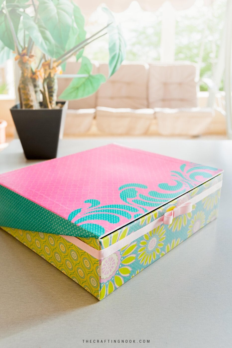 How to Mod Podge a Box with Scrapbook Paper showing the box closed on a table