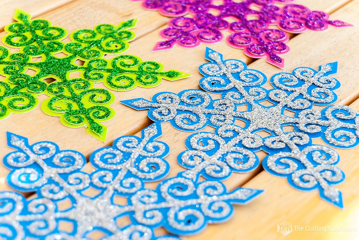 close up showing various blue snowflakes ready
