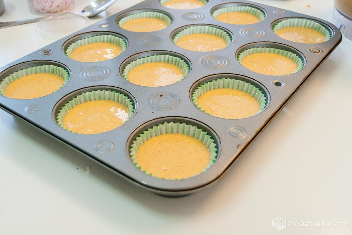 cupcake batter in the muffin pan ready to be baked