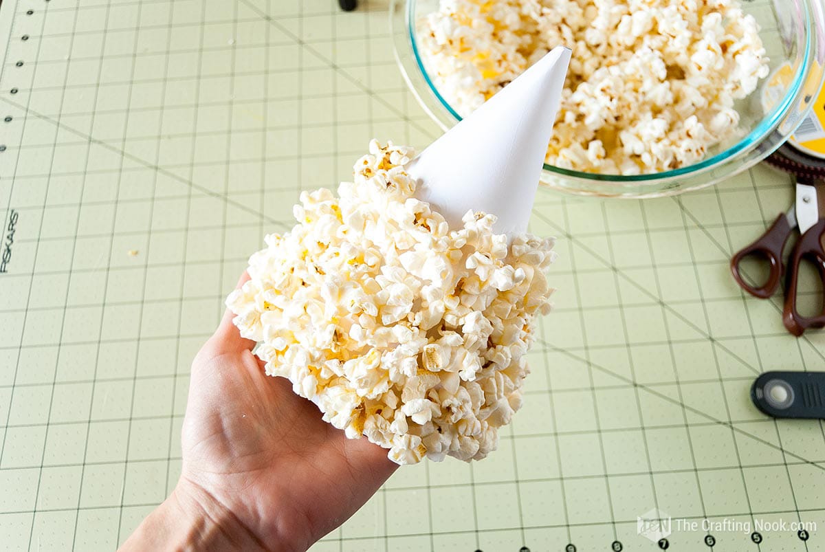 DIY Cone Christmas Trees with popcorn, yarn, and paper - The Crafting Nook