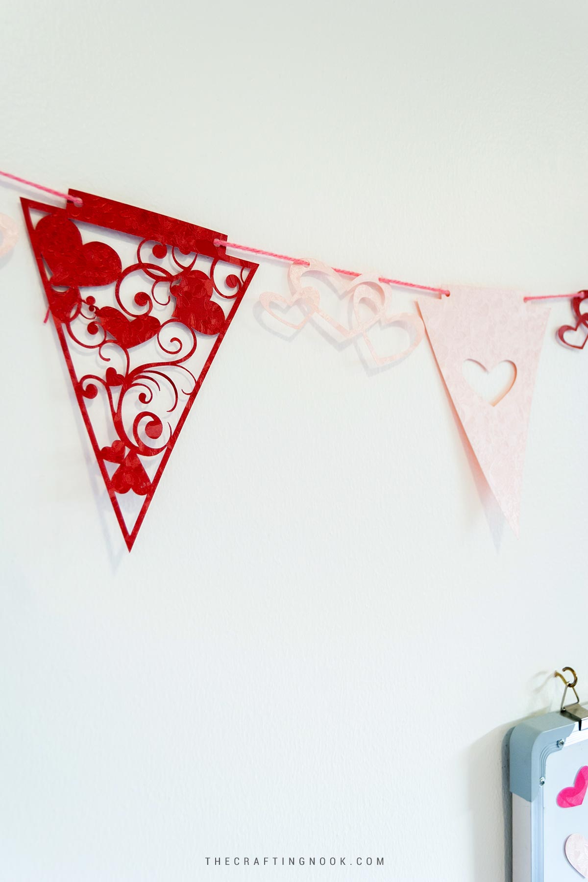 Cute and Easy DIY Valentine’s Day Buntings hangin on a white wall Cover image with Title text overlay