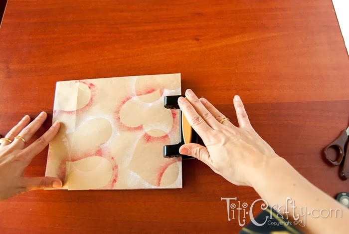 opening holes in the top of the bag with hole punch
