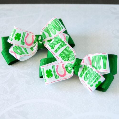 2 DIY No sew Hair Bows for St. Patrick's Day on aa table. Cover image