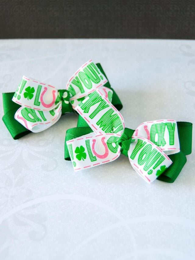 2 DIY No sew Hair Bows for St. Patrick's Day on aa table. Cover image