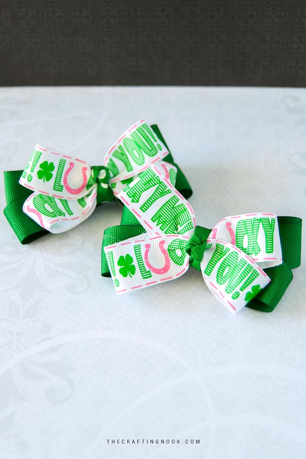 2 DIY No sew Hair Bows for St. Patrick's Day on aa table. Cover image