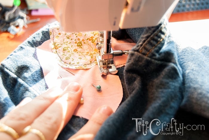 close view of sewing the hearts to the skirt on sewing machine
