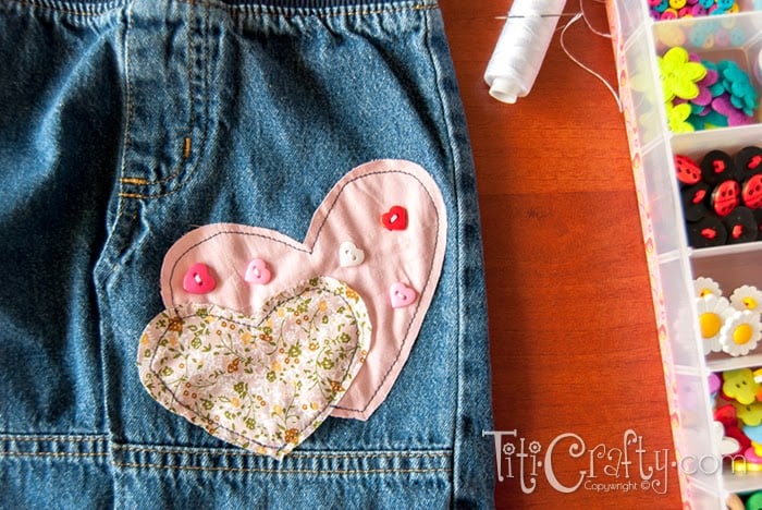 close-up view of hearts sewn to skirt with heart-shaped buttons sewn on
