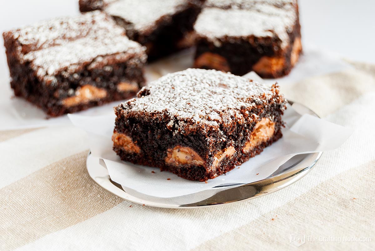 Landscape shot of the Caramel Kahlua Brownies on a silver dish on the table