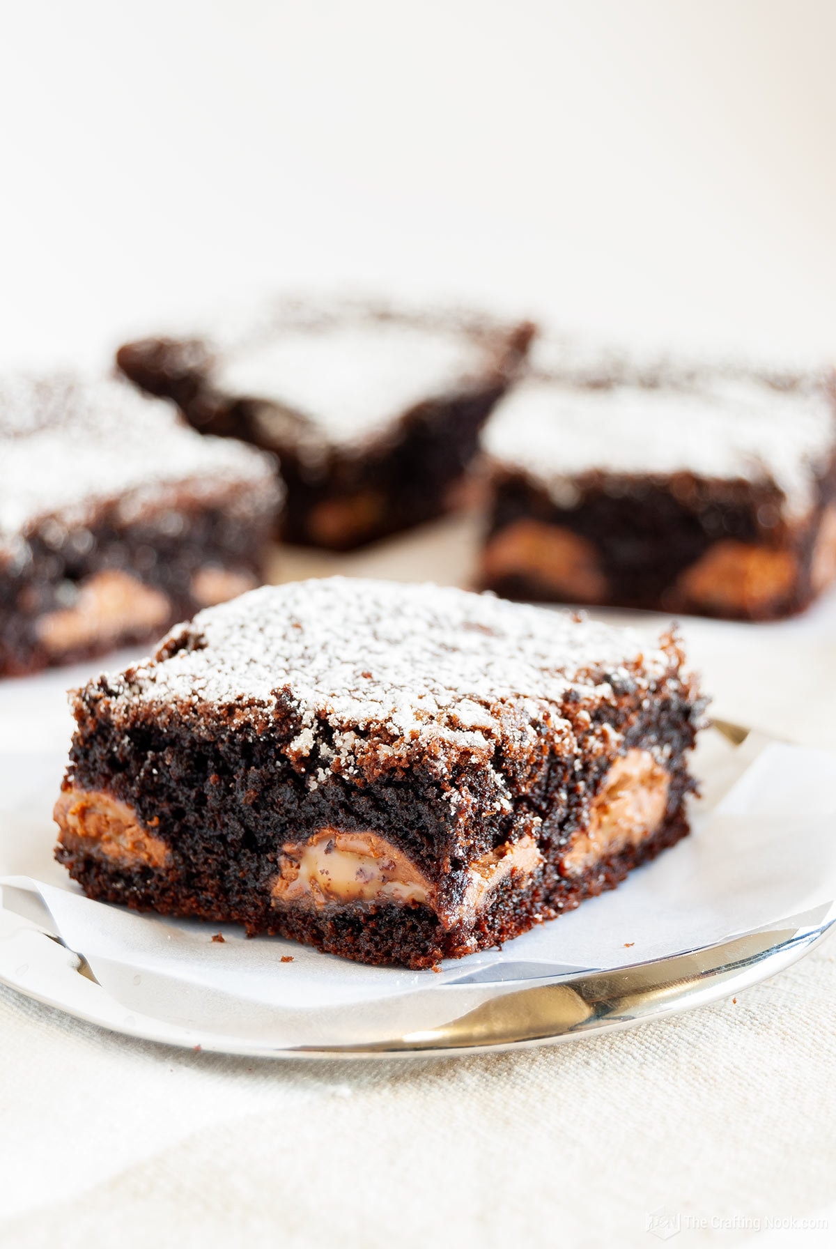 A close shot of the Caramel Kahlua Brownies with some bars on the back