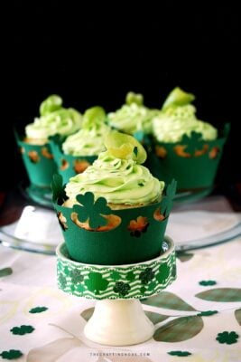 St. Patrick's Day Lime White Chocolate Chip Cupcakes with green buttercream frosting + Free cupcake liner files. Cover image.
