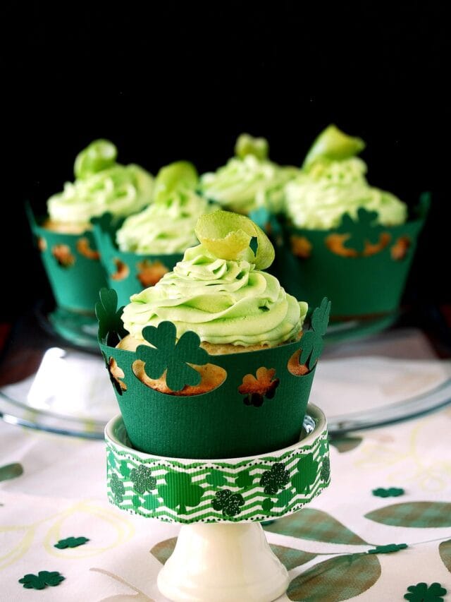 St. Patrick's Day Lime White Chocolate Chip Cupcakes with green buttercream frosting + Free cupcake liner files. Cover image.
