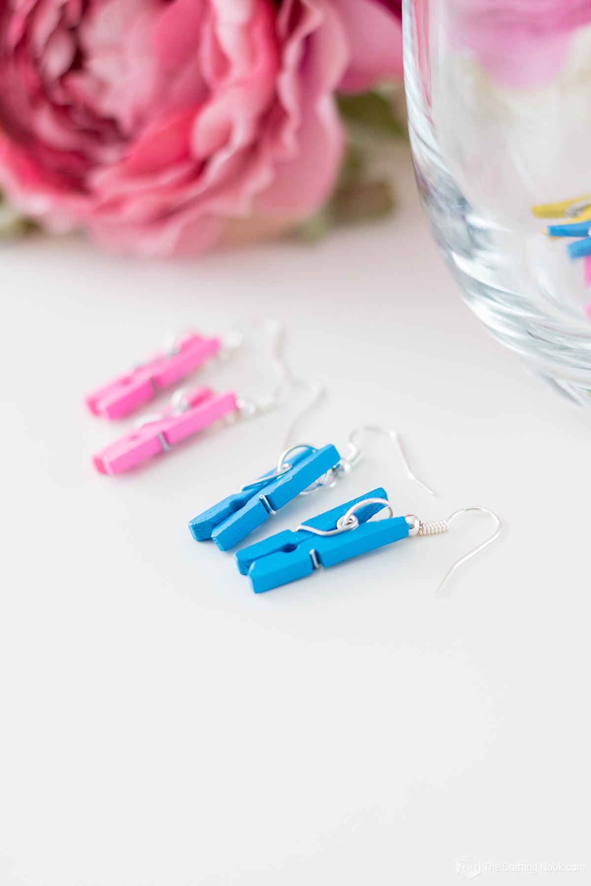 Pink and blue DIY Mini Clothespin Earrings on a table