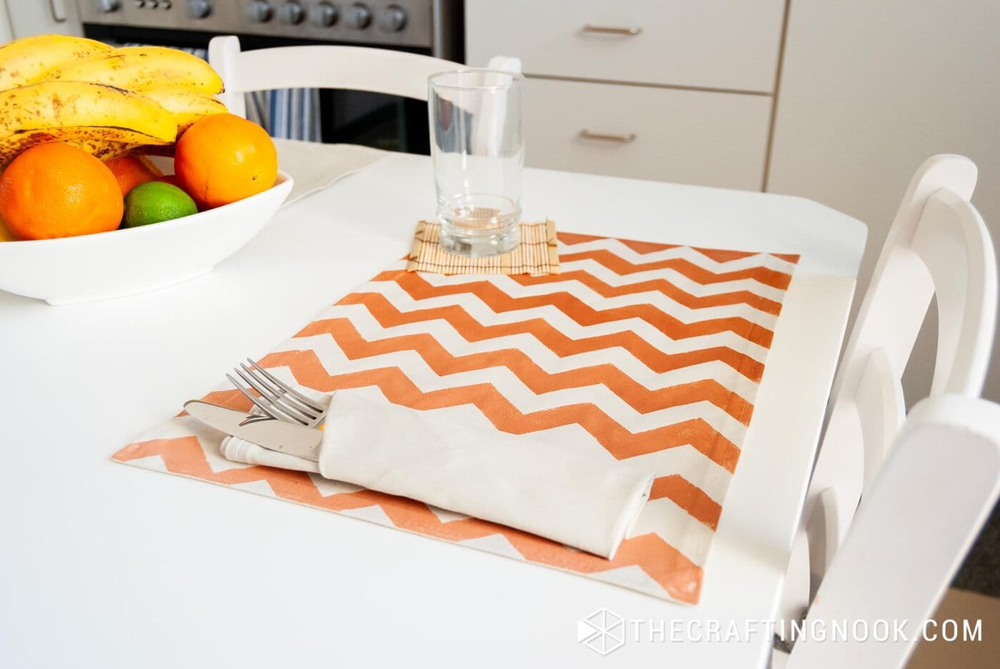 DIY Fabric Placemats with Chevron painted effect on the dining table along with fork and a glass