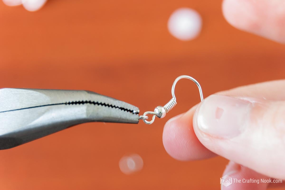 Placing the small jump ring on earring hook
