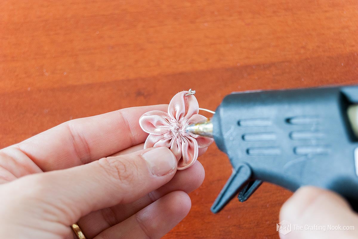 Applying hot glue to the earring
