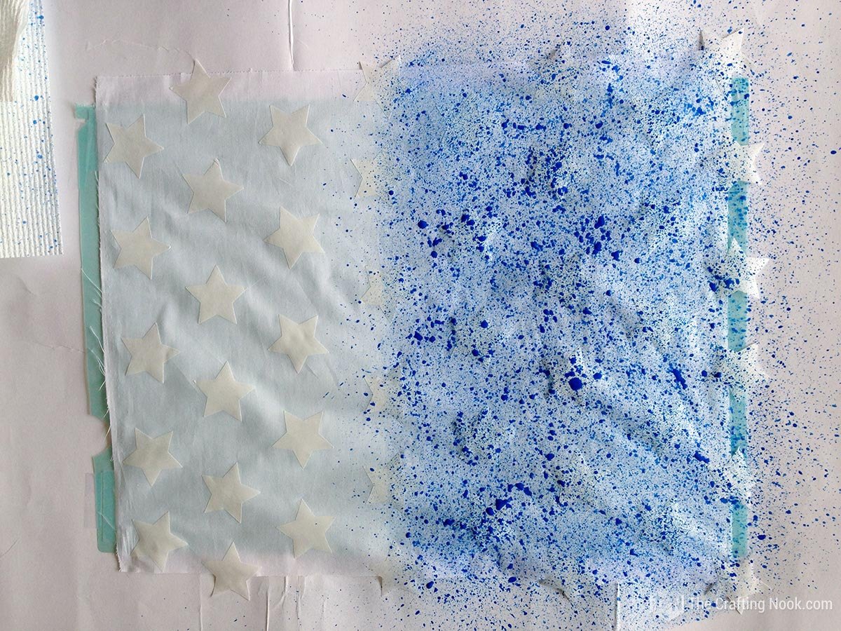 half fabric overed in blue splats