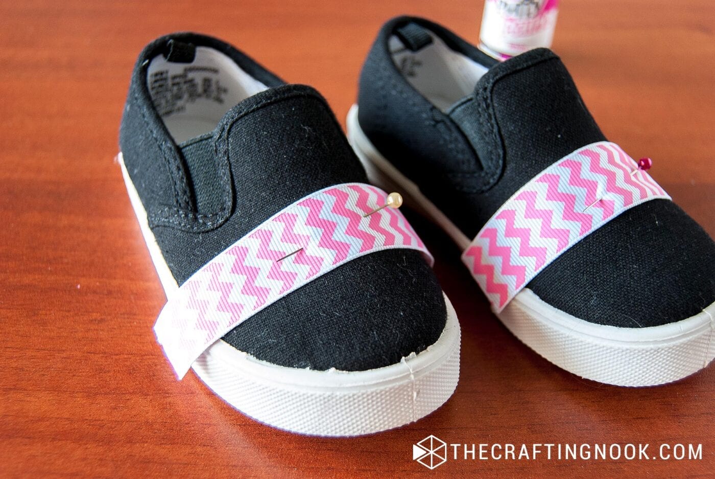 placing 2 strips of chevron ribbon over the toes of the shoes with a few extra millimeters to fold and pinned
