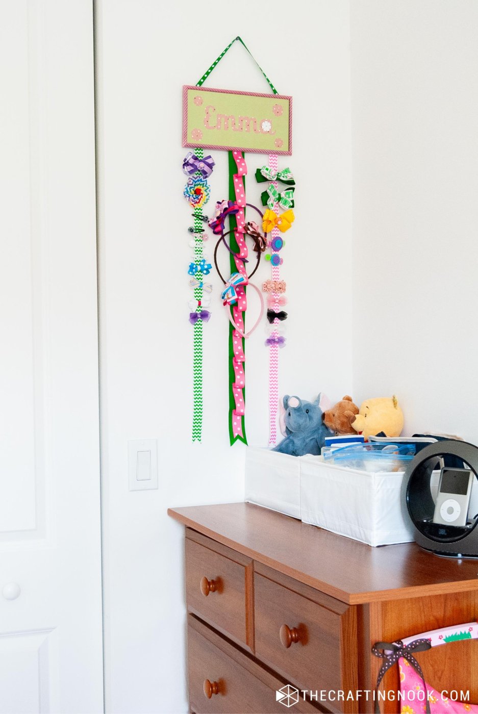 general view of the DIY Hair Bow Holder hanging on a wall above a dresser