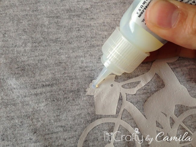 closeup of applying a fabric glue dot on t-shirt