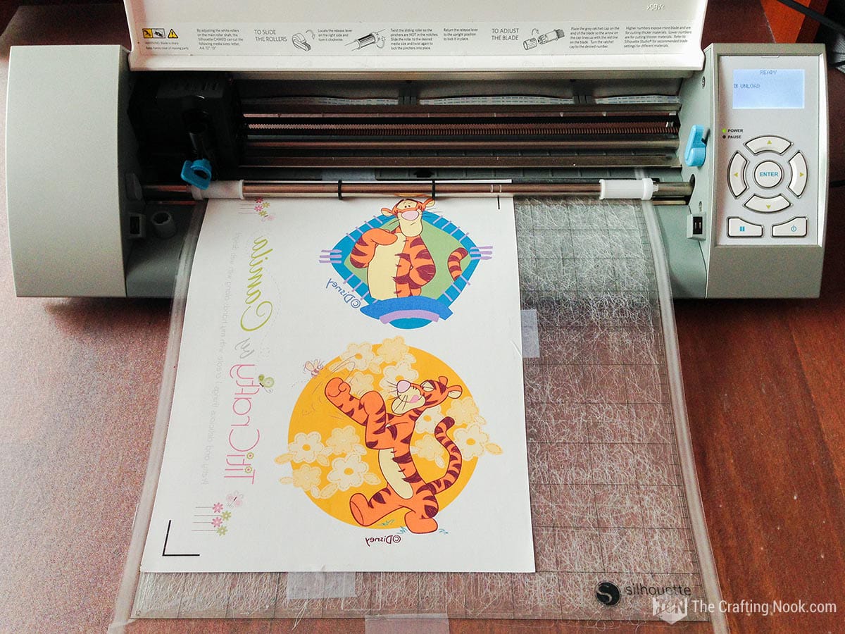 inserting the printed design into the cutting machine