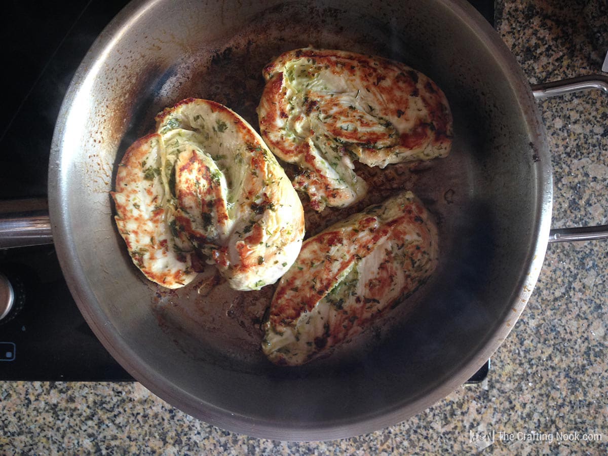 view from above of pan with chicken breasts being cooked