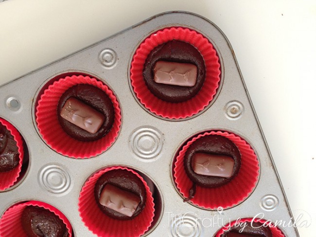 top view of half filled cases with brownie batter. Add a little giggle in each case