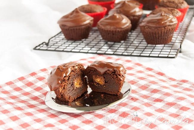 Snickers Stuffed Brownies with Chocolate Ganache cut in half
