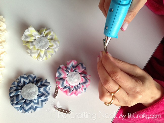 applying hot glue to the clips