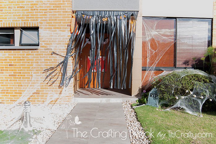 Front Door Halloween Decor with the wind moving the pastic curtain letting the monster to be seen