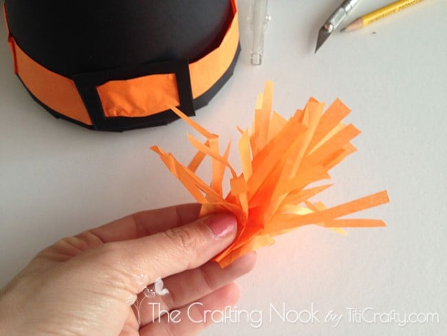 showing a small tassel from the same orange wrapping tissue