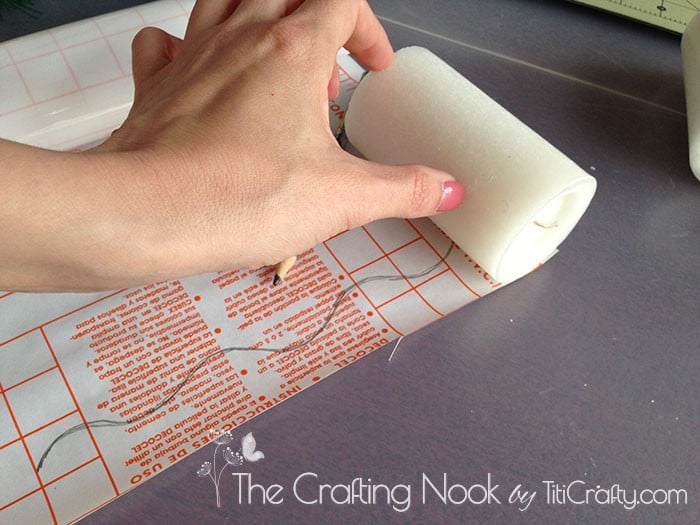 placing the candle on the contact paper to measure the border